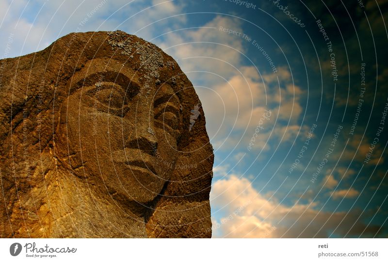 Lord of all time Statue Sandstone Monument Dark clouds Storm clouds Bad weather Weathered Ferocious Facial expression Bust Art Sculptor Head Sky