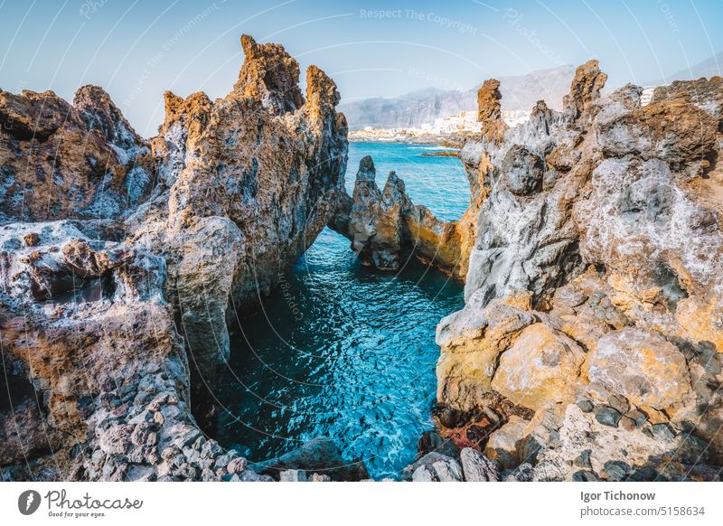 Natural swimming pool. Charco el Diablo, bizarre lava volcanic rock cliffs near to town Puerto de Santiago. Incredibly beautiful turquoise ocean water. Tenerife, Canary island, Spain.