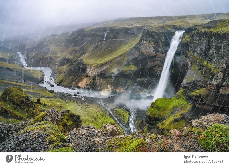 Highlands of Iceland. Haifoss waterfall and River Fossa stream in the valley. Hills and cliffs are coverd by green moss landscape river iceland haifoss summer