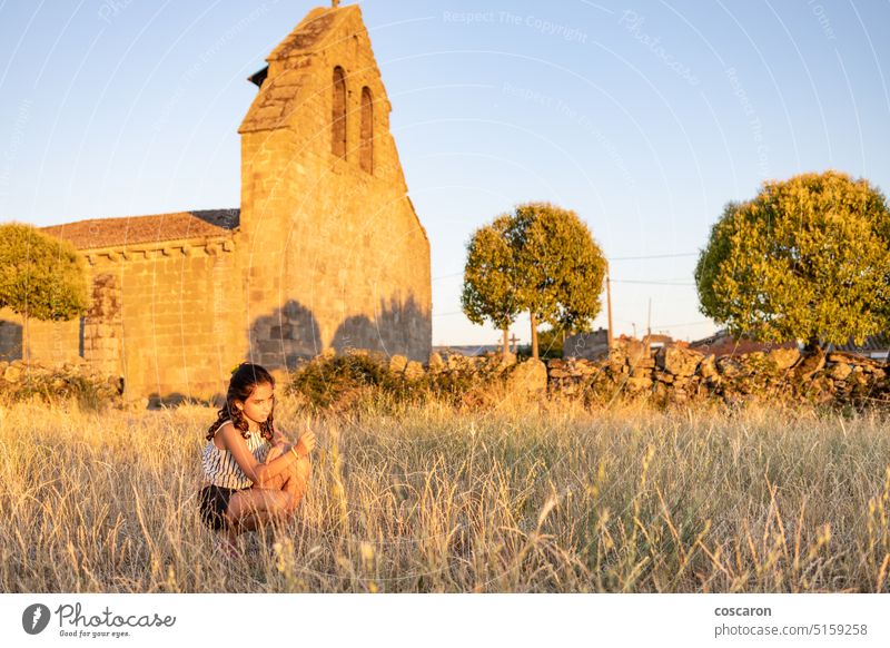 Country girl on a meadow with a church in the background beautiful portrait building child childhood children church building country country style countryside