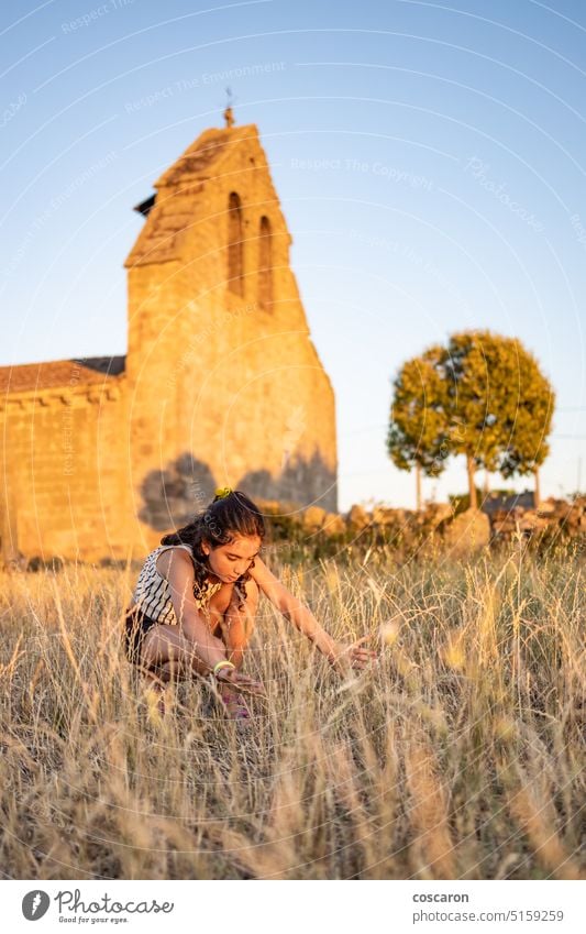 Country girl on a meadow with a church in the background beautiful portrait building child childhood children church building country country style countryside