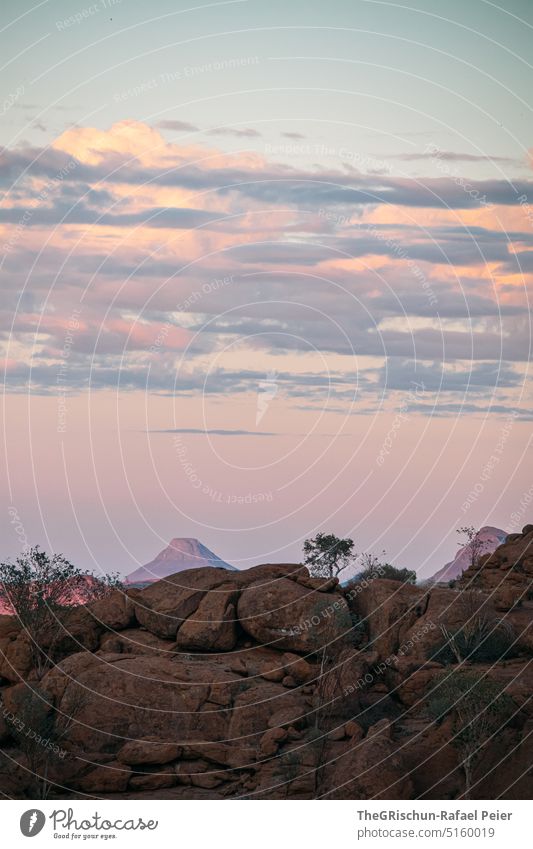 Stone hill in front of mountains in evening mood Namibia dessert camp Steppe Landscape Exterior shot Nature Deserted Environment Far-off places