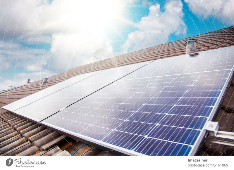 Green electricity balcony power plant. Solar panels on the roof. Close up of photovoltaic system against sun rays in sunny sky. Nature technology