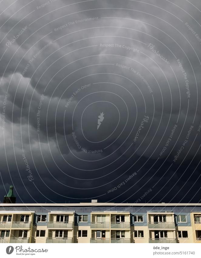 Haunting over skyscraper Storm clouds Clouds Sky Thunder and lightning Threat Bad weather Gale Elements Prefab construction agglomeration cloud face Dark