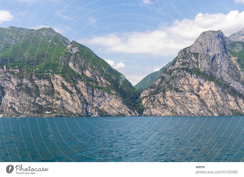 Wooded mountain top and rock wall on the northern shore of Lake Garda in Italy Mediterranean Rock wall alps climbing copy space italian italy lake landscape