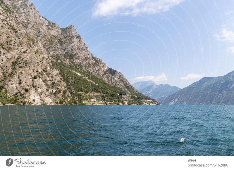 Wooded mountain top and rock wall on the northern shore of Lake Garda in Italy Mediterranean Rock wall alps climbing copy space italian italy lake landscape