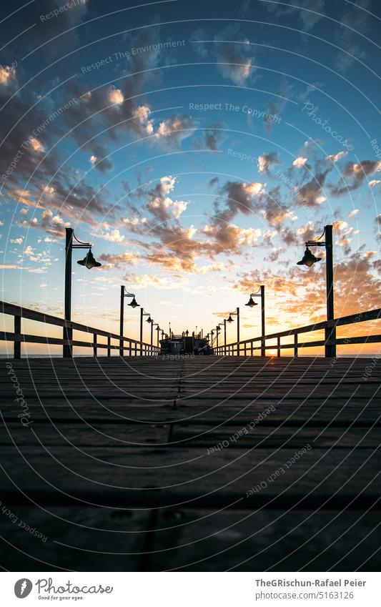 Sunset with jetty and lamps Sky Footbridge Sunlight Clouds Moody Horizon Swakopmund Evening Nature Twilight Vacation & Travel rail lines Namibia