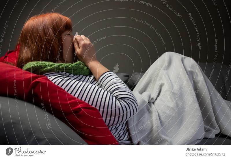 Cold season|woman lying on the sofa and blowing her nose cold spell Healthy Common cold Health care Infection pandemic flu Virus covid-19 medicine infectious