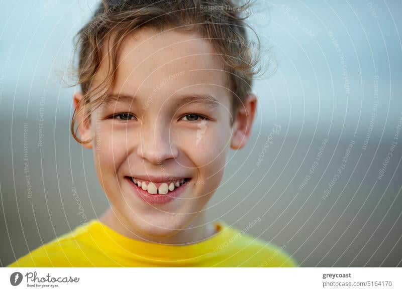 Portrait of a happy boy with curly hair outdoors portrait teenage child kid laugh excited joy cheerful adolescent joyful emotion laughter happiness smile enjoy