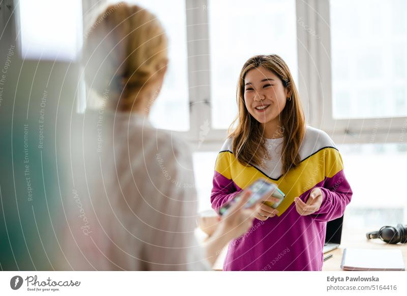 Young female freelancer working in loft office real people millennials student indoors window natural girl adult one attractive successful confident person