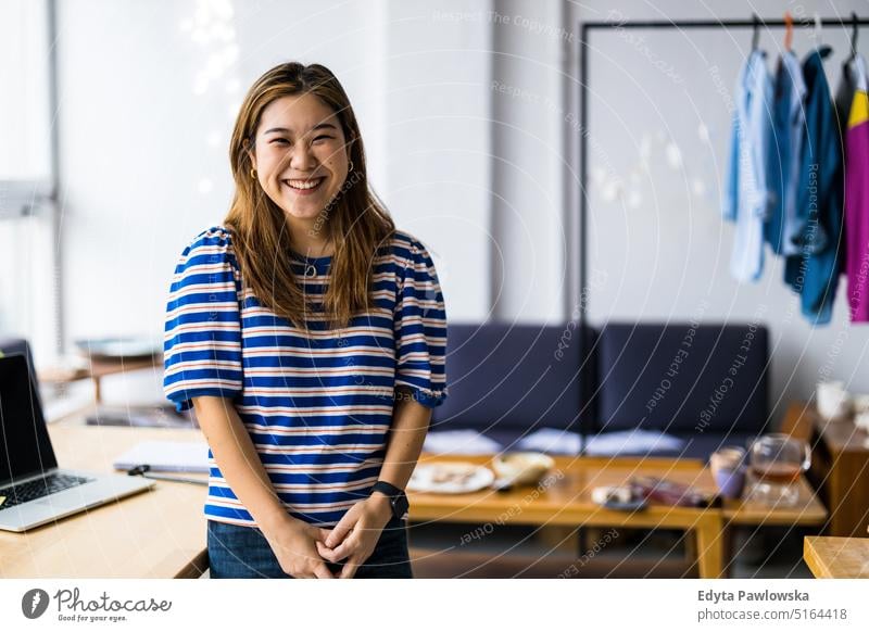 Female fashion designer in her loft studio real people millennials student indoors window natural girl adult one attractive successful confident person