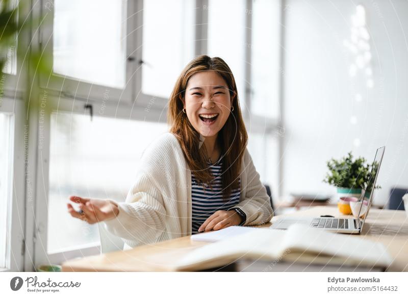 Young female freelancer working in loft office real people millennials student indoors window natural girl adult one attractive successful confident person