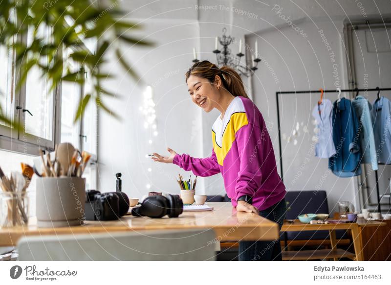 Young female freelancer working in loft office real people millennials student indoors window natural girl adult one attractive successful confident person