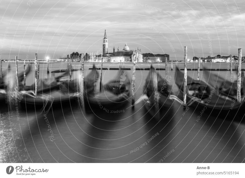 Venice- parked gondolas in beautiful motion blur and view of San Giorgio Maggiore . Probably everyone takes this picture. With me it is black and white.