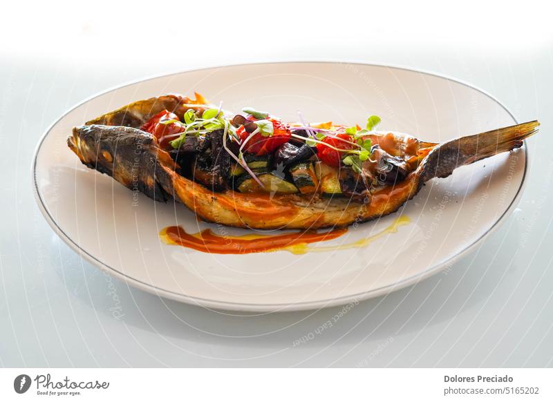 Dish of baked bream with vegetables in a gourmet restaurant aurata bass carrot cooking cuisine dark delicious diet dinner dish dorada dorado fish food fresh