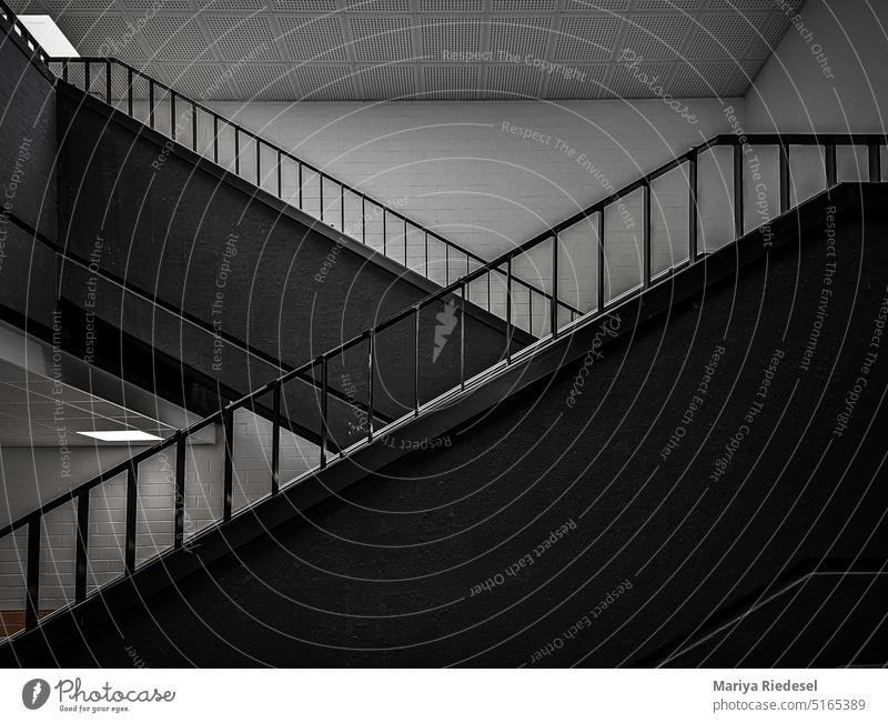 two sets of stairs selling against each other no people Empty Past Lonely Deserted b/w unrefurbished Moody Black & white photo Contrast Stairs Interior shot