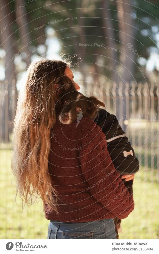 Caucasian woman holding puppy. Adopted border collie dog held by a caucasian woman with long blond hair. Friendship and family. adoption friendship adorable