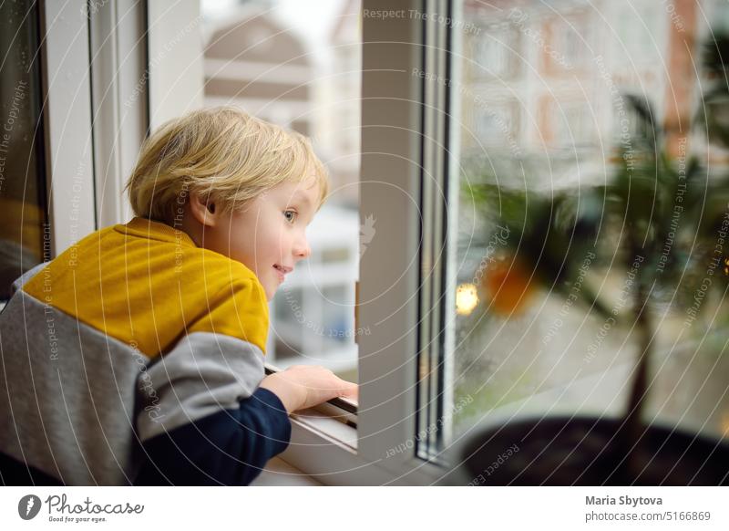 A child of primary school age is at risk of falling from a window from a great height falling out unlocked open kid little preschooler windowsill home unsafe