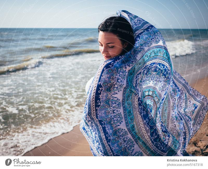 Gypsy girl wearing white maxi dress standing near the sea or ocean windy beach woman beautiful beauty boho gypsy hippie style summer attractive female bohemian