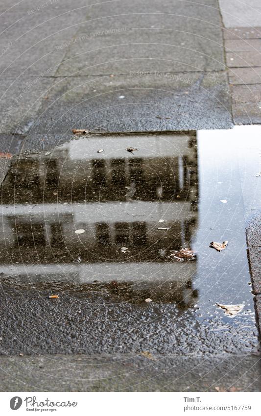 Puddle with reflection in Leipziger Street Berlin Prefab construction Reflection Architecture Water Sky Tower block Facade Silhouette Structures and shapes