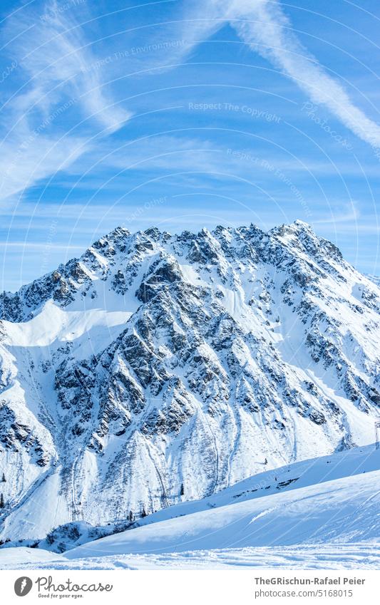 Snow covered mountain in front of blue sky Clouds Blue sky Mountain Montafon Ski resort Tourism Winter Landscape Sky Alps Winter vacation Winter sports Ski run