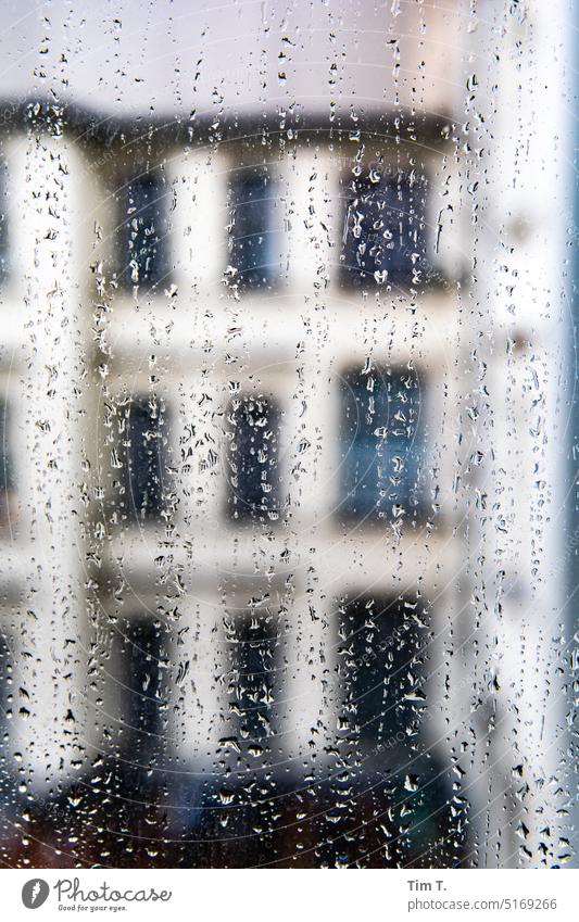 View through a rainy window pane into the courtyard Berlin Prenzlauer Berg raindrops Window Colour photo Interior courtyard Interior shot Downtown Town