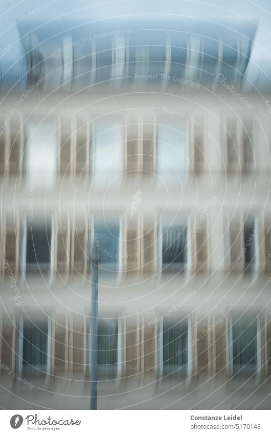 House facade with evenly spaced windows and street light in ICM Window Glazed facade motion blur City dwell blurred abstract photography Unclear Calm hazy