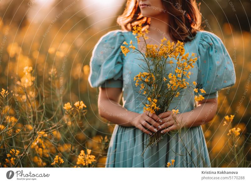 Happy woman in blooming canola flowers field. Lady in retro dress, spring season agricultural background beautiful beauty blonde blossom bright canola field