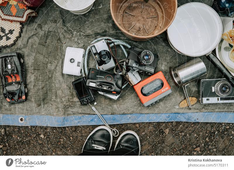 Prague, Czech - February 2023. Top view of older cameras 90s on sale flea market vintage buy people hand antique city retail retro sell shop woman second