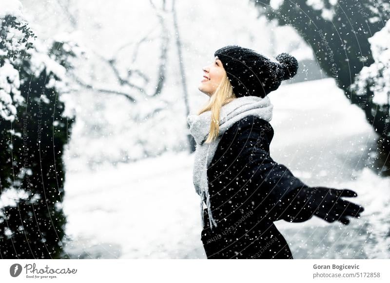 Young woman in warm clothes enjoying in snow beauty model girl person young winter nature outdoor happy white frost season day emotions coat adult wear air