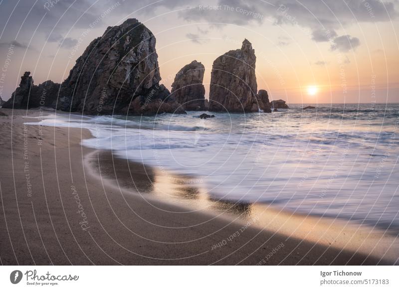 Portugal Ursa Beach. Beautiful sea stacks rocks in sunset light. White atlantic ocean waves on empty sandy beach ursa portugal coast travel vacation golden