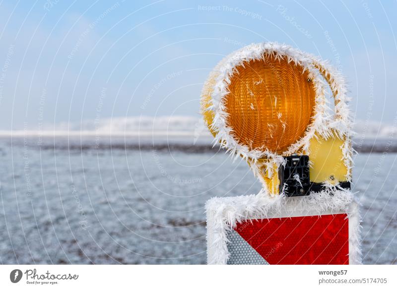 Single hoarfrost decorated beacon on a construction field Hoar frost Winter Cold freezing cold ice crystals Construction site construction site safety