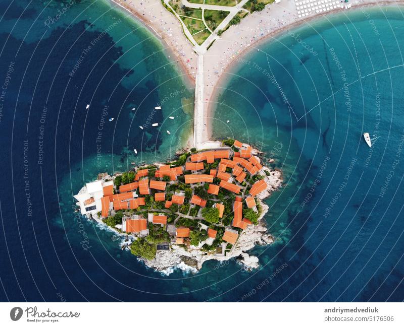 Aerophotography. Aerial view of Sveti Stefan island in a beautiful summer day, Montenegro from flying drone. Panoramic above view of Saint Stephen luxury resort. Tourism and leisure concept.