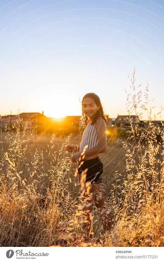 Teen girl exploring a straw field in the countryside adorable adventure agriculture awesome child children colorful cute day daylight female flower fun