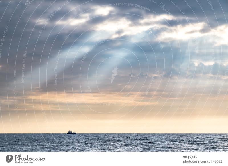 Sun rays on a small boat on the horizon of the Baltic Sea Sunbeam Ocean Horizon ship Clouds vacation Sky Vacation & Travel Freedom Blue Adventure Tourism Water