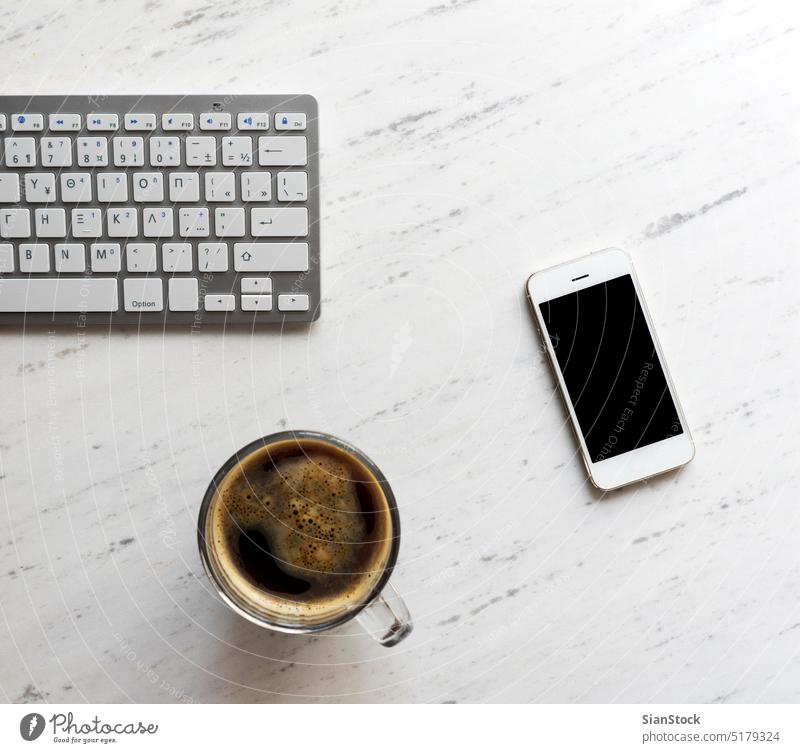 Workplace with smartphone, coffee, keyboard, laptop desk view table office computer cup desktop white above work business background paper notebook pen blank