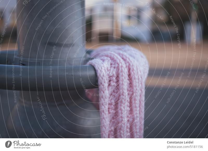 Pink scarf hangs on the traffic light handle for cyclists. Scarf Doomed Wait Traffic light Door handle Hang hang out Transport Town Traffic infrastructure