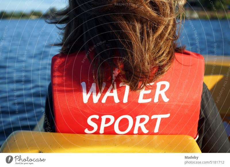 Water sports with the life jacket in the pedal boat in the summer in the light of the evening sun on the Poyrazlar Gölü near Adapazari in the province of Sakarya in Turkey