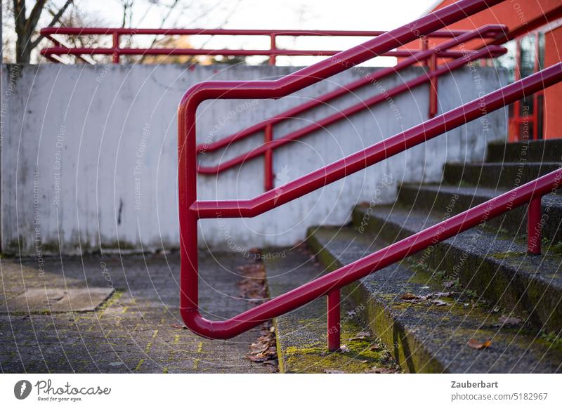 Red stair railing in front of concrete wall, architecture of the 70s Stairs Banister Concrete structure 1970s washed concrete staircase ascent Descent reeds