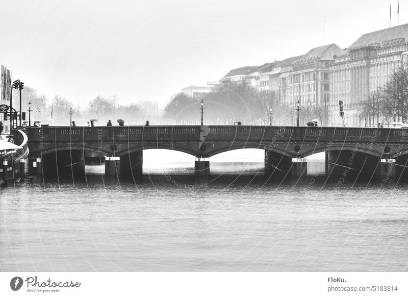 Reesendamm Bridge at Jungfernstieg in Hamburg Rain Gray Water Reflection Exterior shot Wet Street Grayscale Black & white photo Weather Bad weather Day downtown