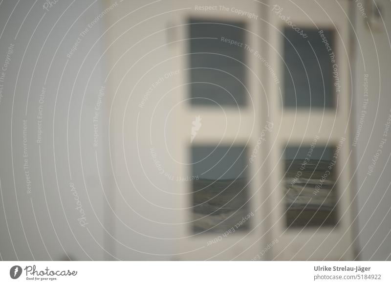 Reflection in window panes of beach hut / beach and waves on North Sea coast Mirror image reflection Reflection in windows Window Window pane