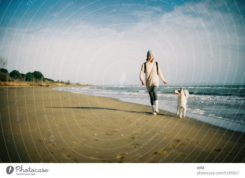 Woman and dog playing on lonely beach Beach Ocean Sandy beach Exterior shot Vacation & Travel Dog laika Yakutian laika muck about Together Love of animals