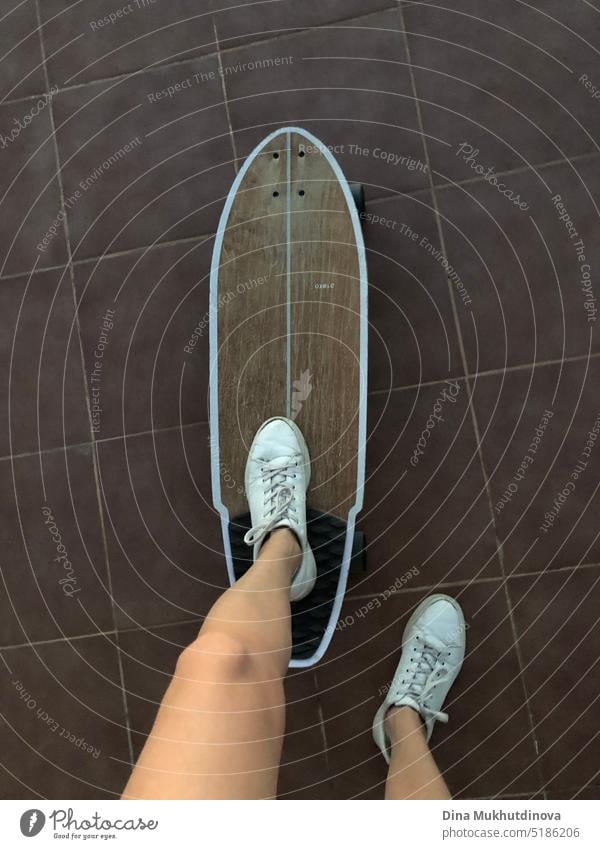 Girl skateboarding in white sneakers. Legs in old leather shoes on a wooden skateboard. skating girl young clothing activity woman trendy happy object leisure