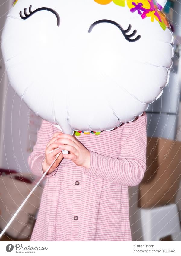 Child with balloon Birthday Balloon Hide Mask Joy Playful Feasts & Celebrations Face Prosopagnosia Face blindness Party Anonymous Happiness Decoration Abstract