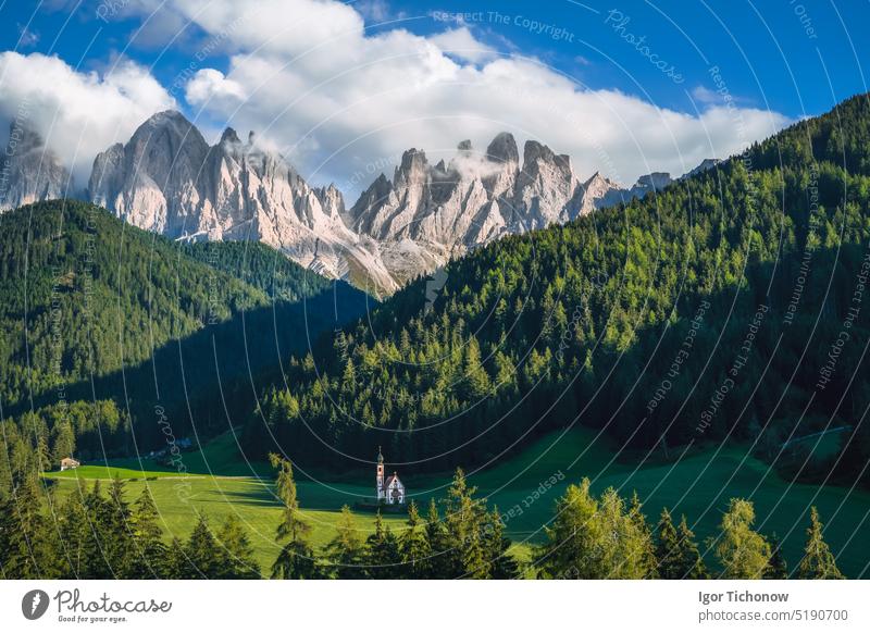 St Magdalena church in Val di Funes valley, Dolomites, Italy. Furchetta and Sass Rigais mountain peaks in background italy dolomites funes landscape nature