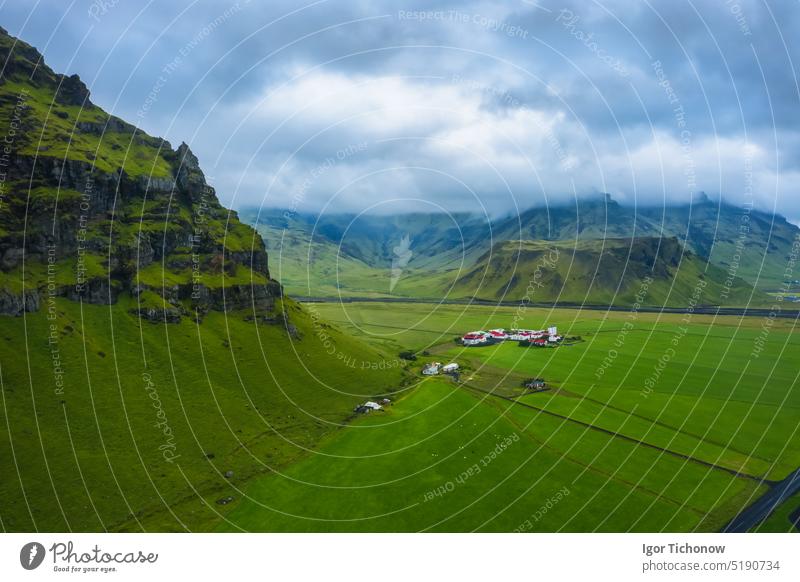 Aerial view of icelandic south coast on ring road. Landscape in Iceland at the day time. View from drone. Summer. Cloudy weather. Fresh grass on field. Travel and vacation image