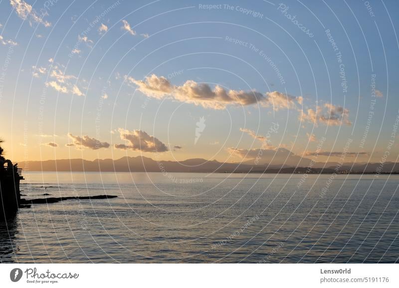 The setting sun coloring the sky over Enoshima, Japan beach cloud enoshima golden horizon landscape mountain ocean orange outdoor reflection sea silhouette