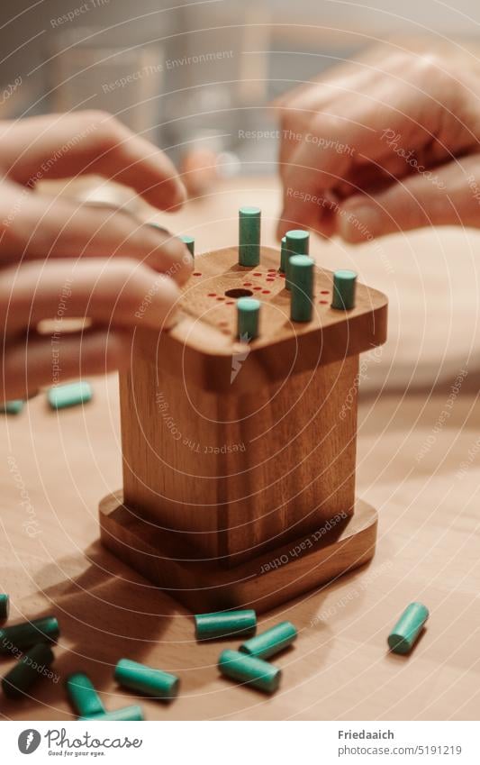 Wooden dice game with green sticks Crap game cubes Playing Happy Throw dice Coincidence Close-up Leisure and hobbies Detail Fingers Joy Family time Colour photo