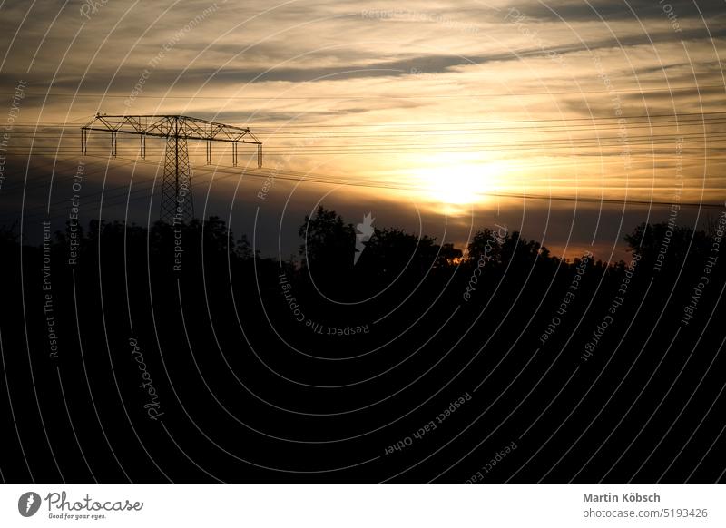 High-voltage power pole with overhead line through which the electricity is transported high voltage energy utility power cable power plant power provider cloud