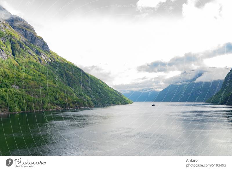 Beautiful fjord landscape with a ship at Hellesylt in Norway travel norway mountains snow covered clouds nobody nature hellesylt ferry boat waterfall falls